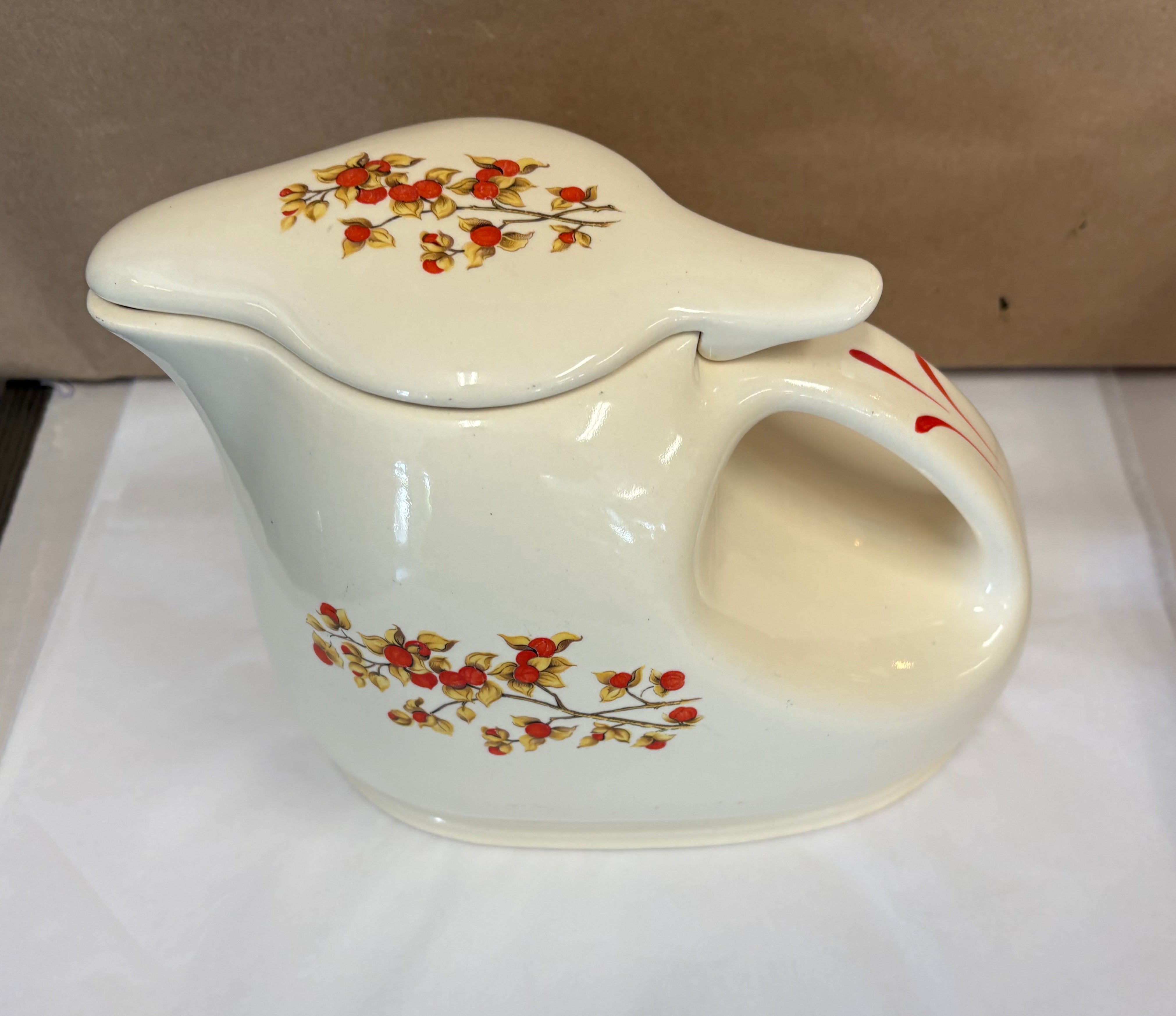 Covered coffee pot in bittersweet pattern made by the Oxford Ware China Company.