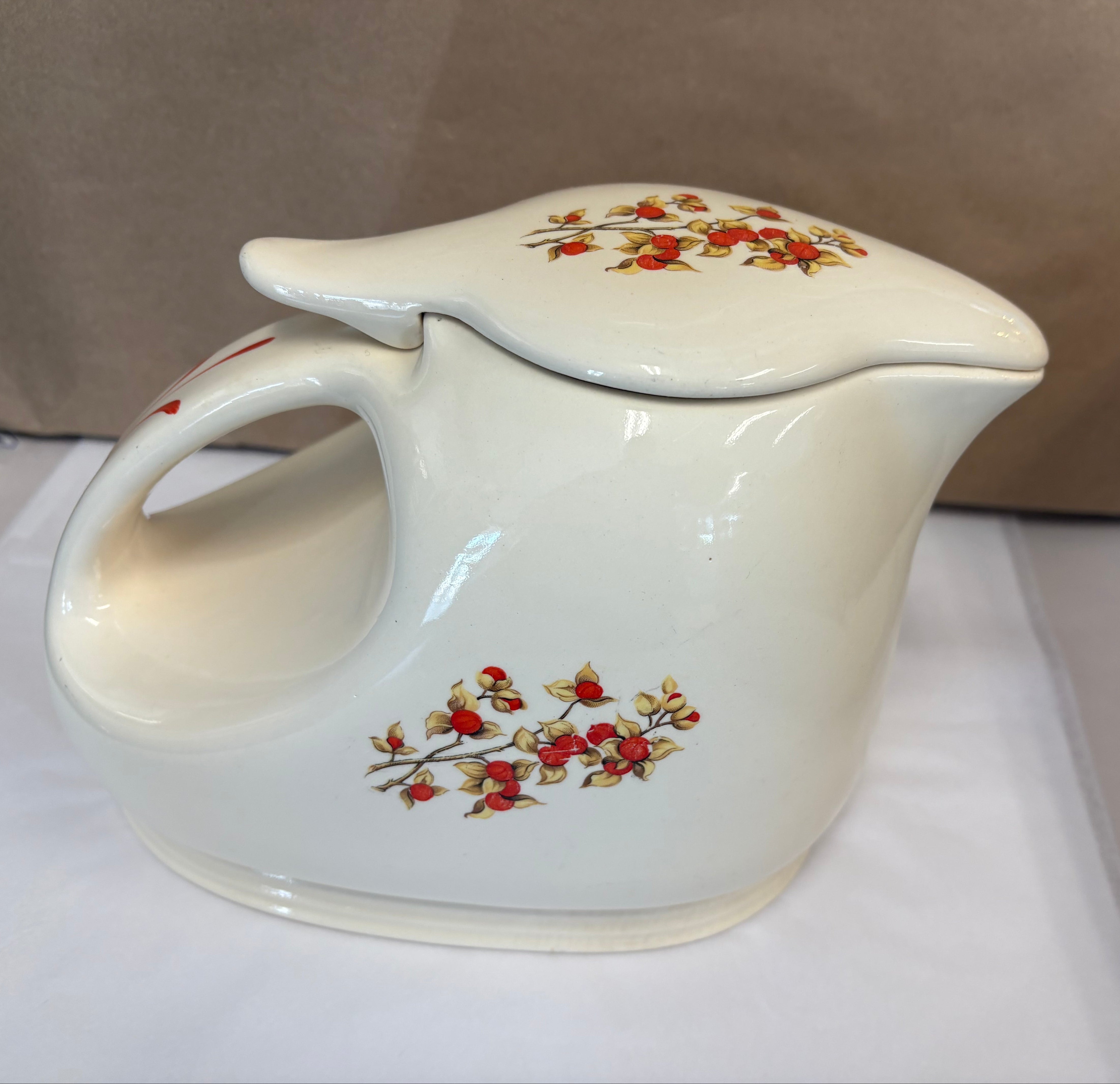 Covered coffee pot in bittersweet pattern made by the Oxford Ware China Company.