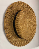 Antique straw boater hat with a black band and bow