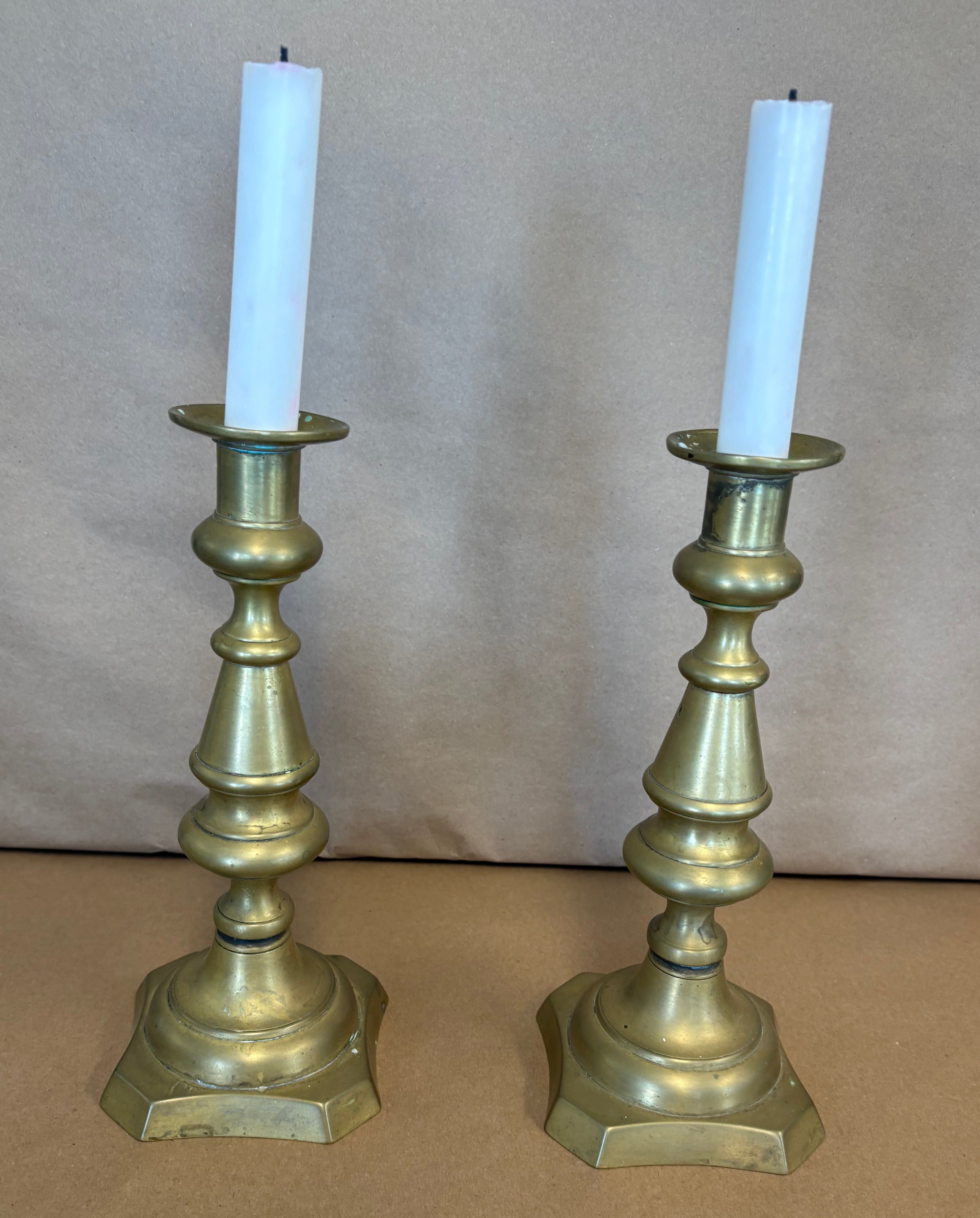 pair of tall brass candle sticks