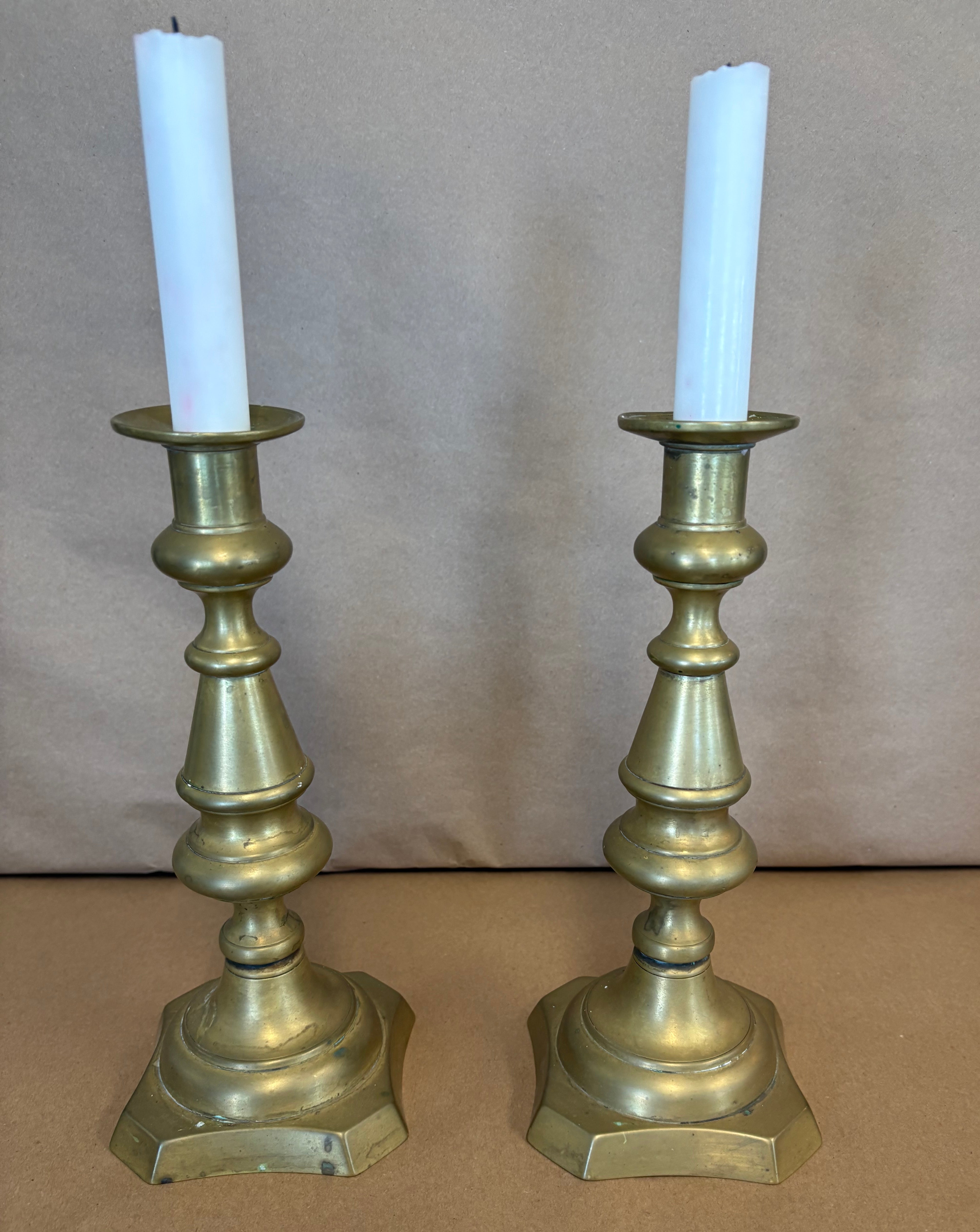 pair of tall brass candle sticks