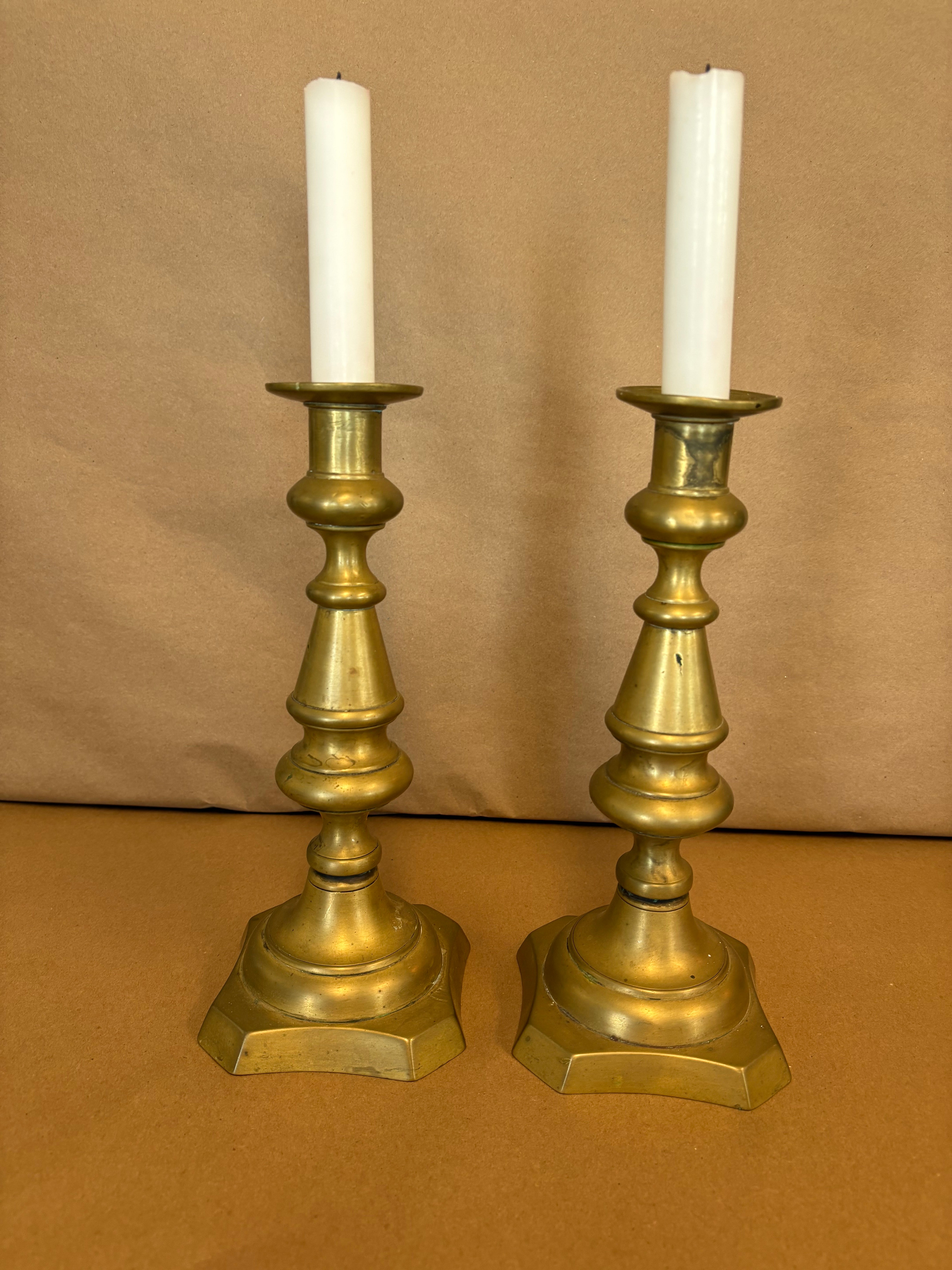 pair of tall brass candle sticks