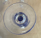 set of 7 stemmed blue goblets with a gold band along the rim