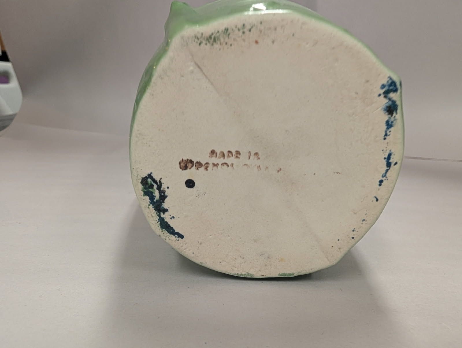 Czechoslovakian green vase with a bird on a swing amidst flowers