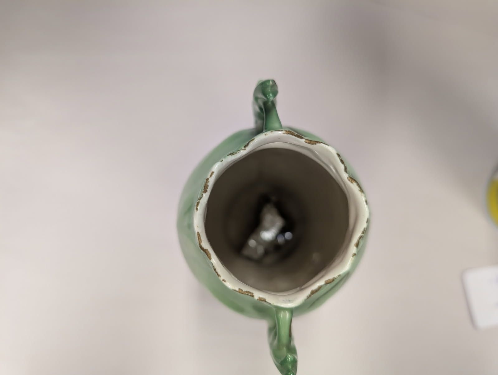 Czechoslovakian green vase with a bird on a swing amidst flowers
