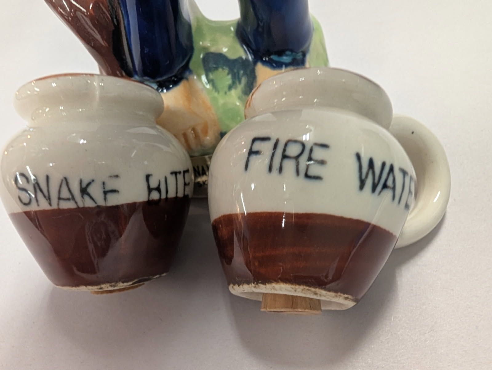 Salt & pepper shaker of an oriental man carrying jugs