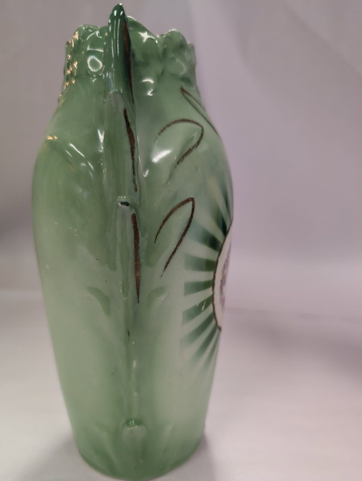 Czechoslovakian green vase with a bird on a swing amidst flowers