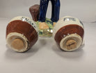Salt & pepper shaker of an oriental man carrying jugs