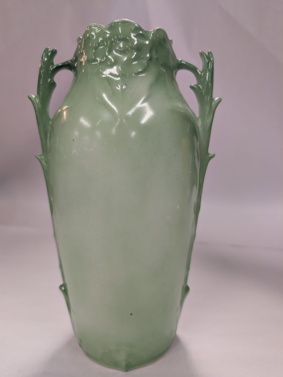 Czechoslovakian green vase with a bird on a swing amidst flowers
