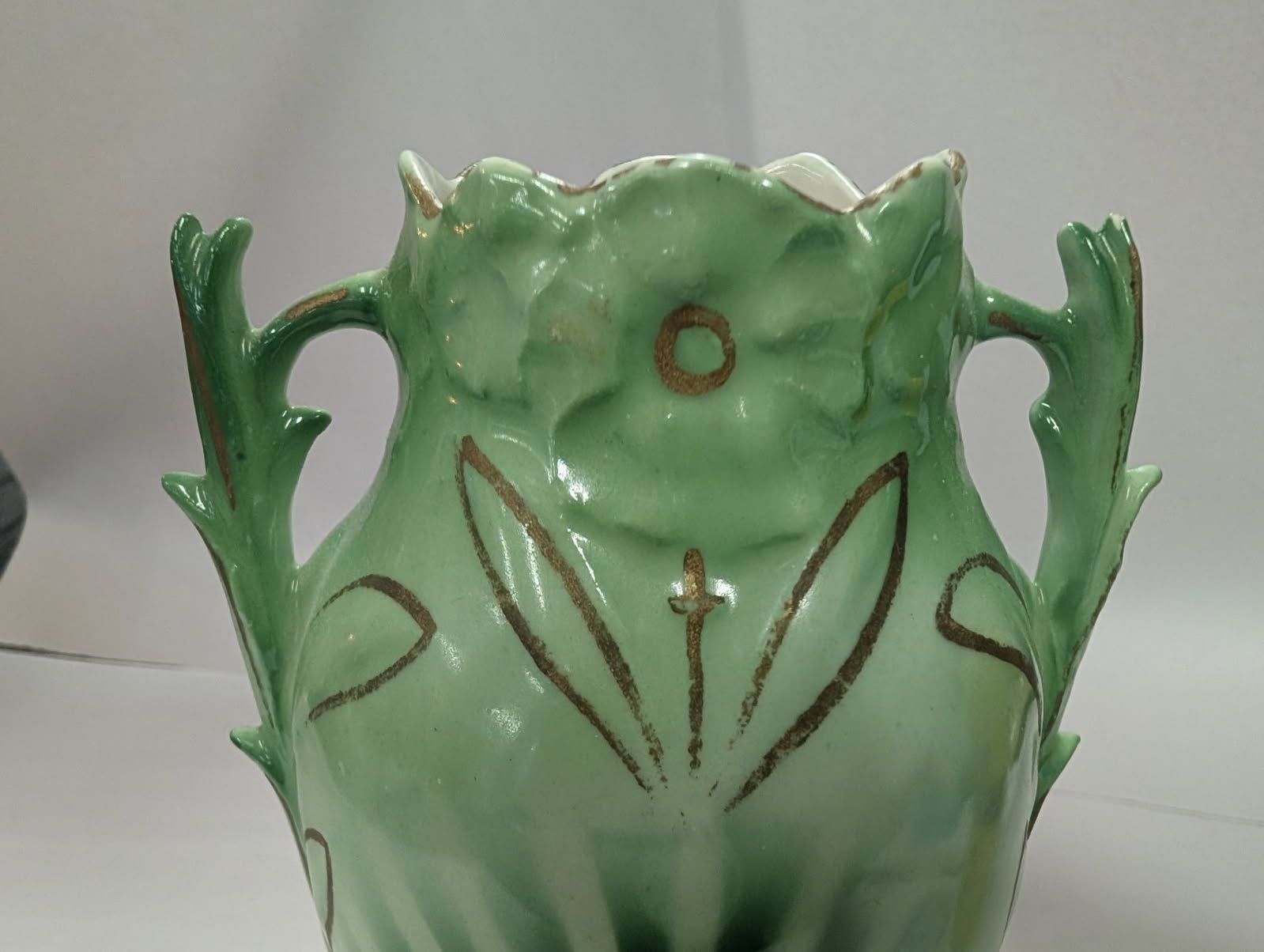 Czechoslovakian green vase with a bird on a swing amidst flowers