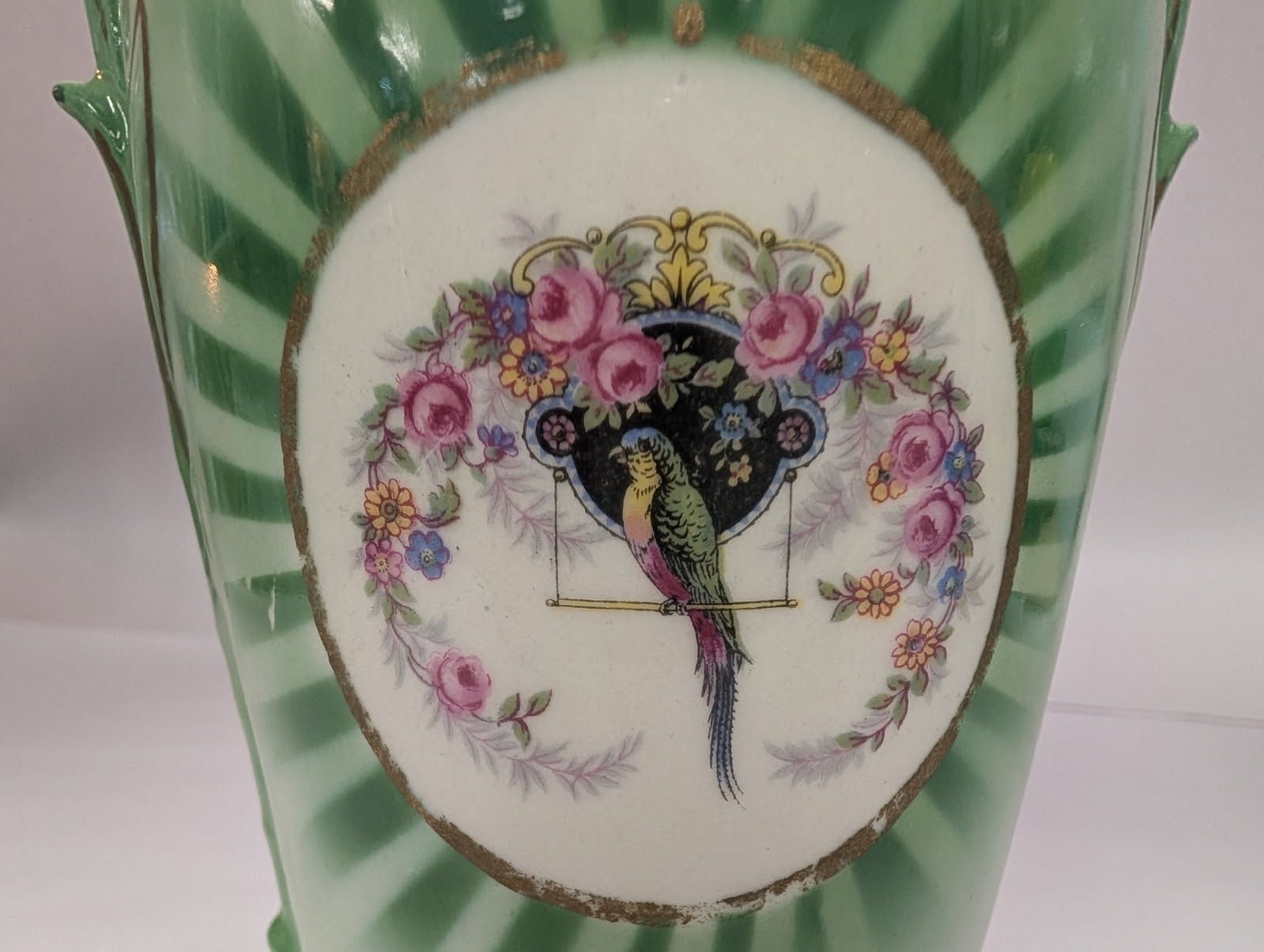 Czechoslovakian green vase with a bird on a swing amidst flowers